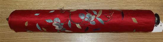 A Chinese red silk banner embroidered with figures, flowers, insects and calligraphy,